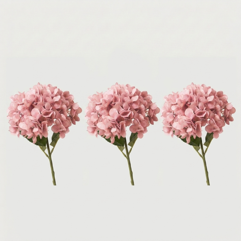 Three pink faux hydrangea stems on white background