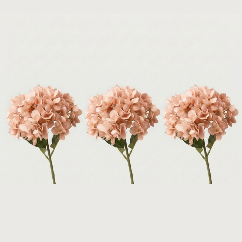 Three peach faux hydrangea stems on white background