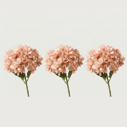 Three peach faux hydrangea stems on white background