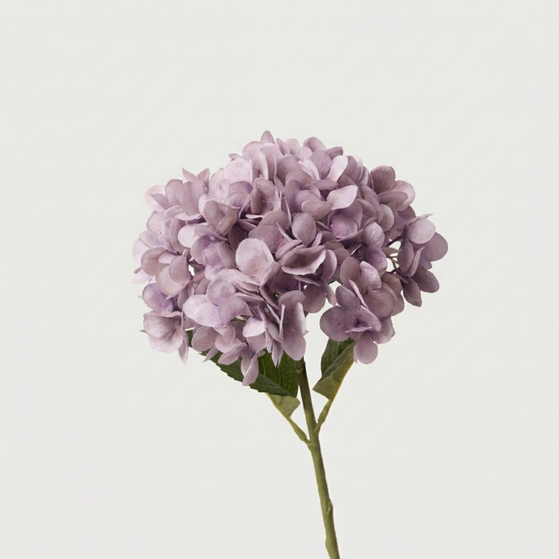 Purple faux hydrangea stem on white background