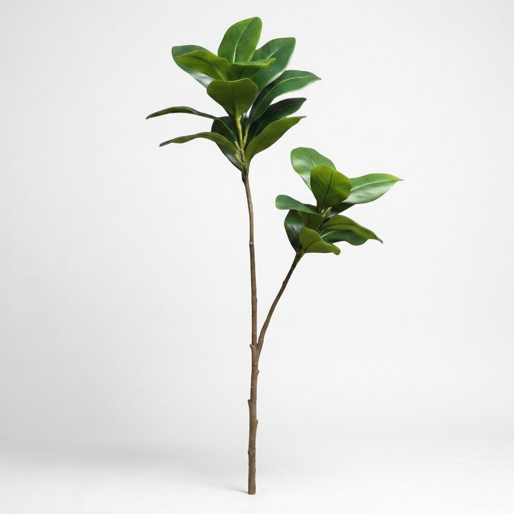 Single faux magnolia tree stem standing alone on a plain studio background