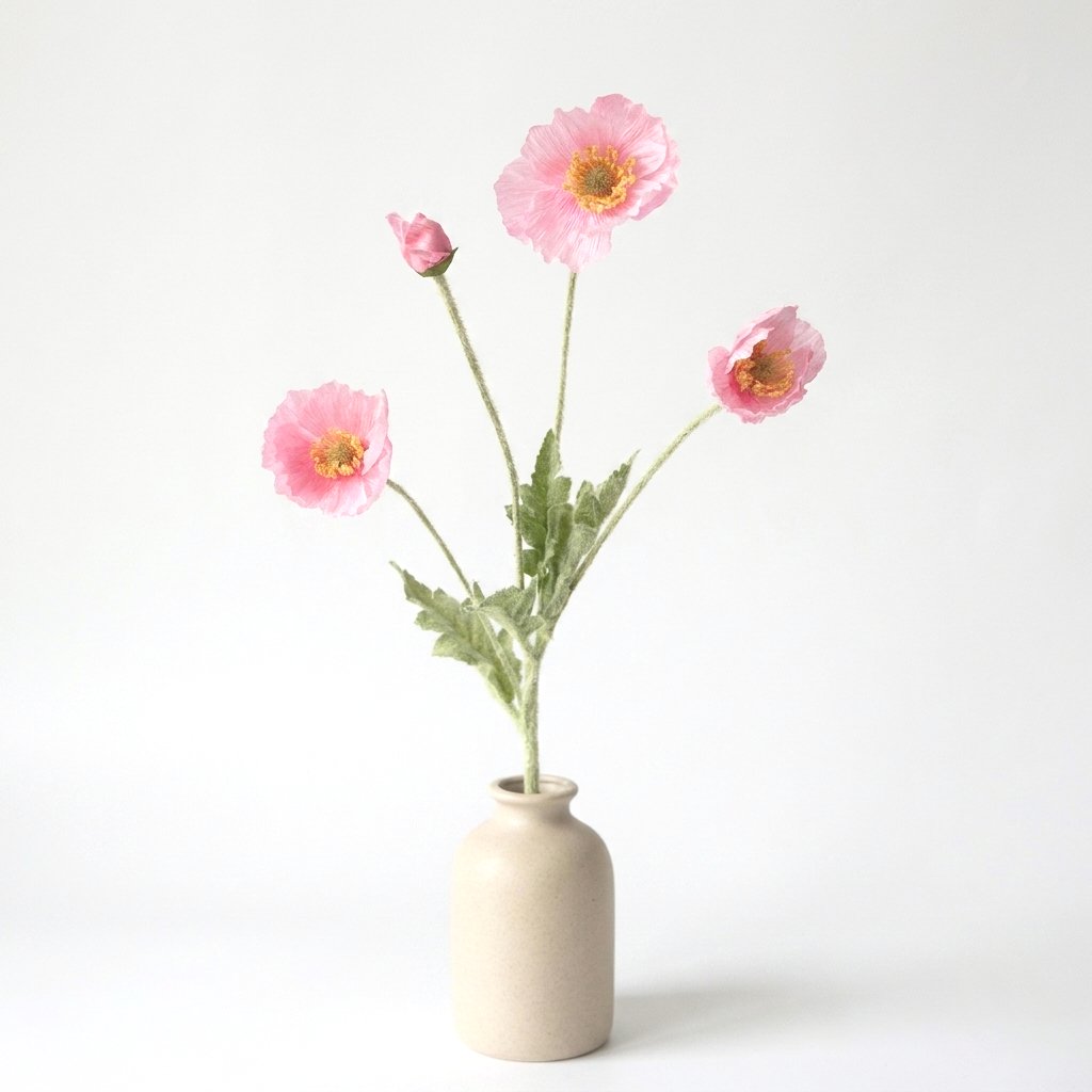 Four faux poppy stems with three medium rose-pink blooms and a deeper pink bud in a beige ceramic bottle vase on a plain light backdrop