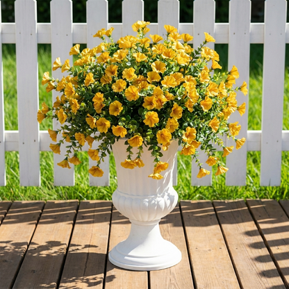 Yellow faux UV-protected flower stems in white urn planter