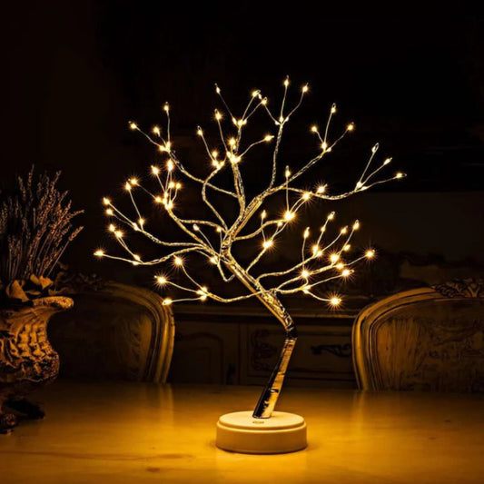 Firefly tree decorated on a kitchen table at night.