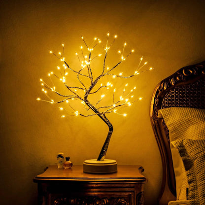 Firefly tree illuminating at night on a bedside table.