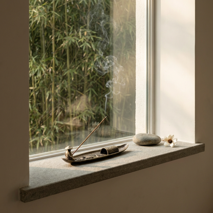 Fishing boat incense burner on windowsill in natural light