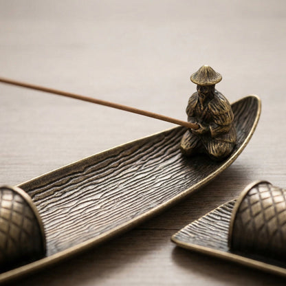 Close-up of fishing boat incense burner with incense stick