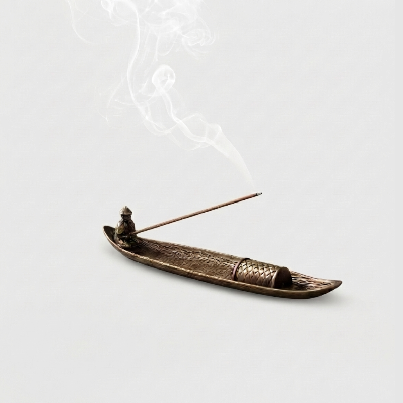 Fishing boat incense burner on white background with incense stick