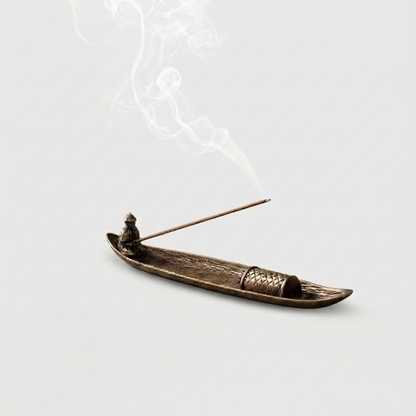 Fishing boat incense burner on white background with incense stick