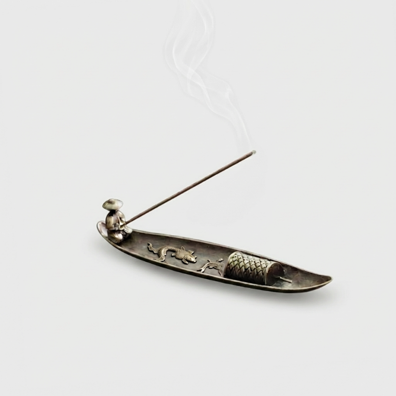 Fishing boat incense burner on white background with incense stick
