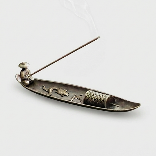 Fishing boat incense burner on white background with incense stick