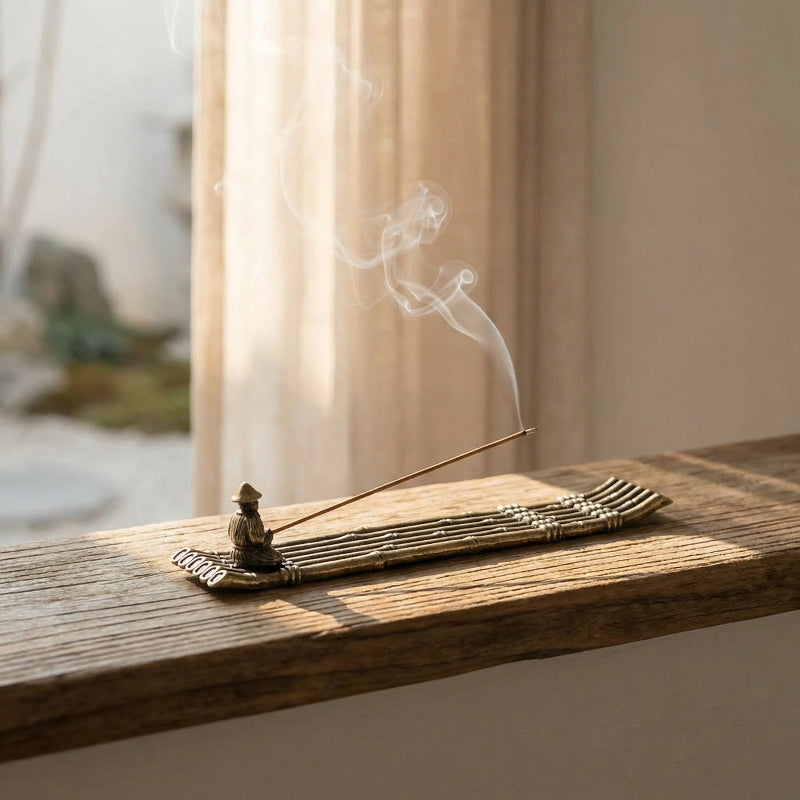 Fishing boat incense burner on windowsill with soft smoke