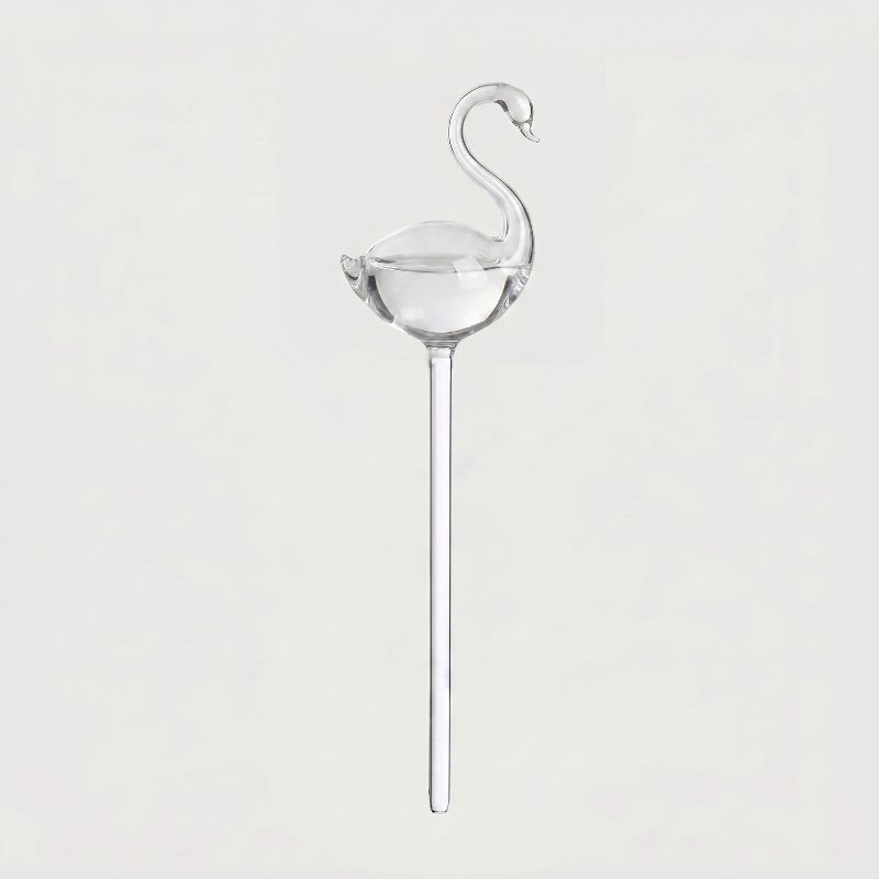 Swan self-watering glass plant vessel on white background