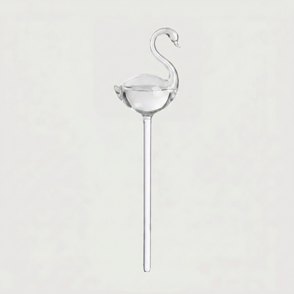 Swan self-watering glass plant vessel on white background