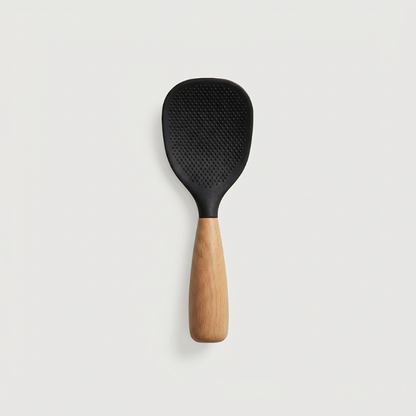 Black spatula with wooden handle on a light gray background