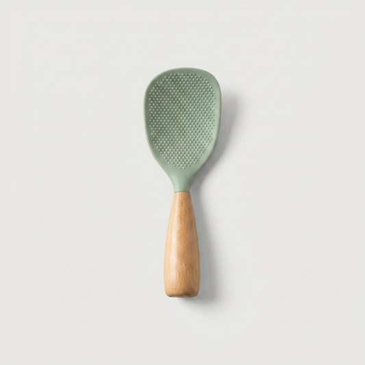 Green silicone paddle with wooden handle on a light gray background
