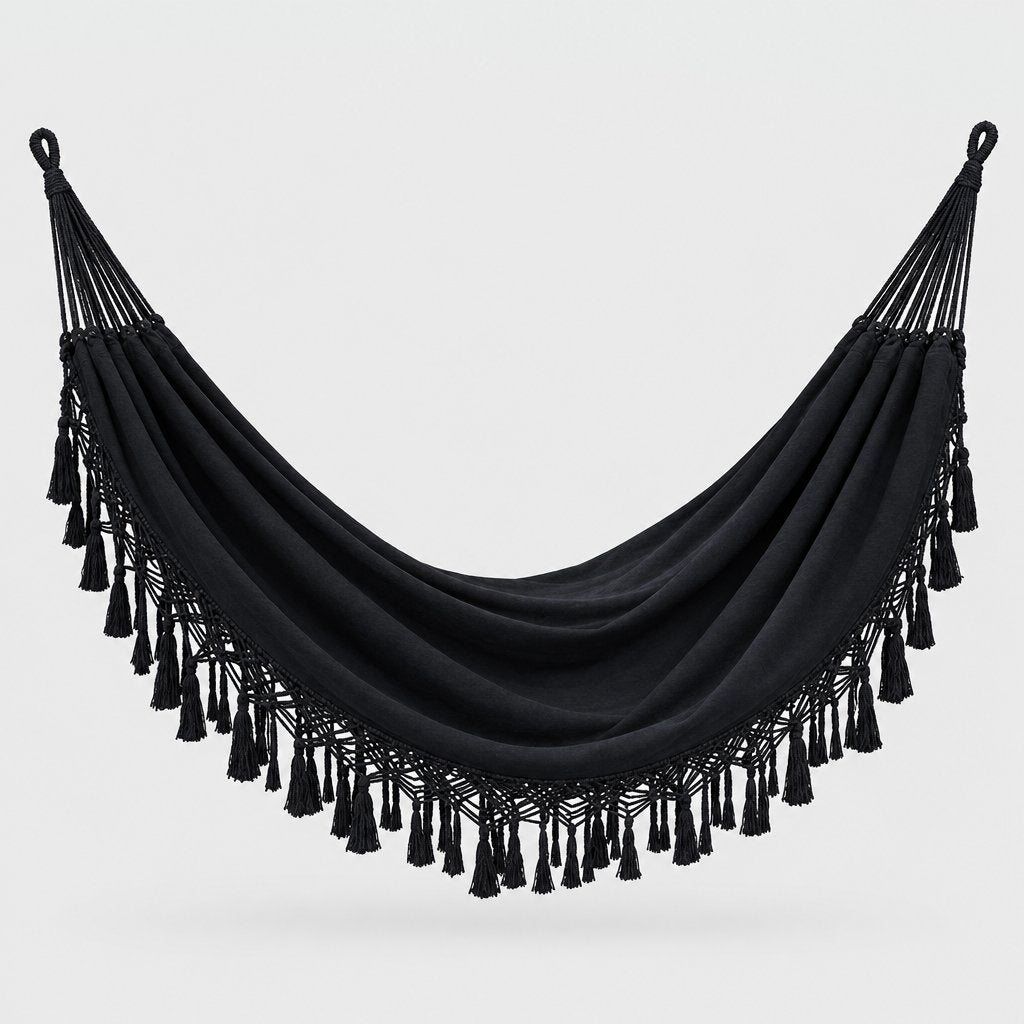 Black fringe macrame hammock with a fine lace border and thick wrapped tassels, with a looped hanging cord at each end, on a plain light gray background