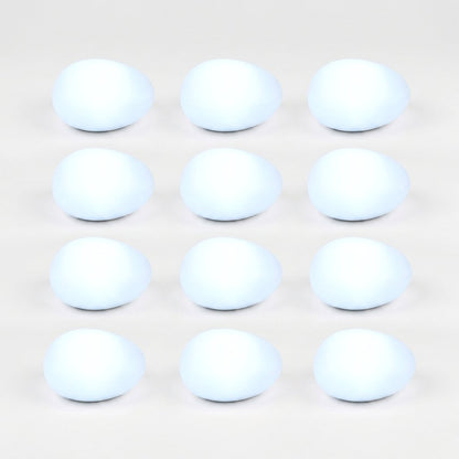 Twelve frosted solar glass pebble lights glowing cool white in a grid of three by four on a light background