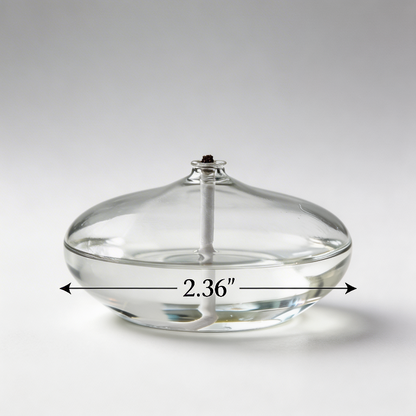 Glass oil candle on white background from side angle