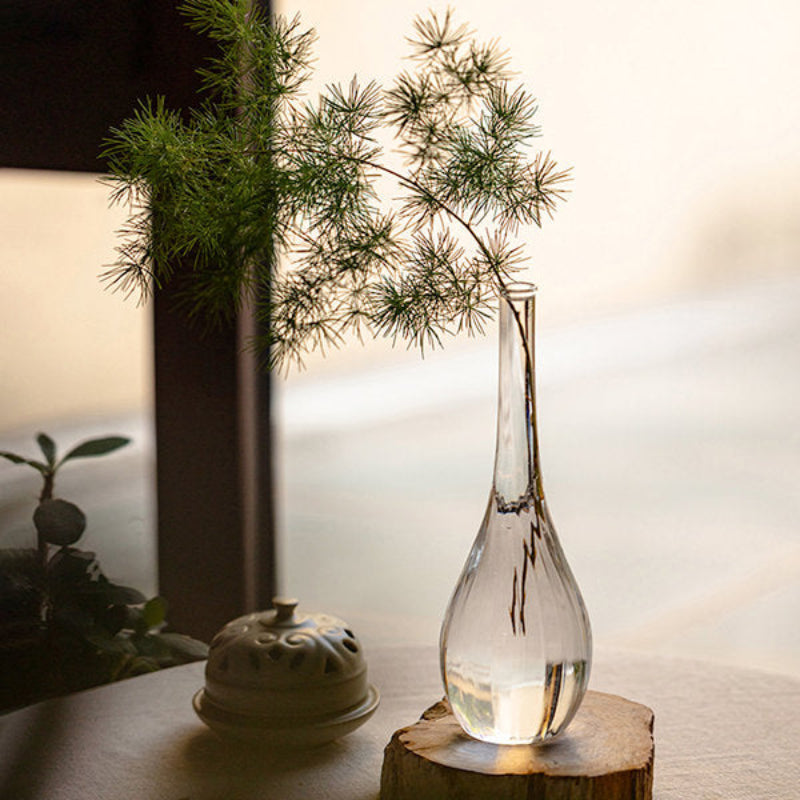 Elegant glass vase filled with fairy lights, displayed on a patio table for an enchanting outdoor evening setup.