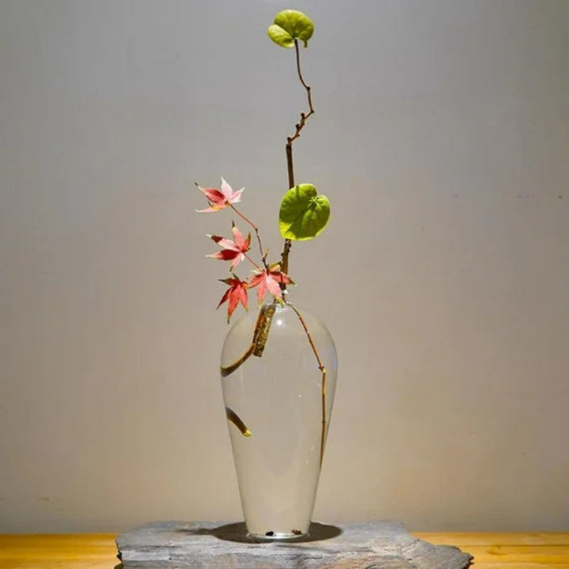 Clear glass vase with tall grasses, styled on a modern sideboard for a natural and earthy vibe.