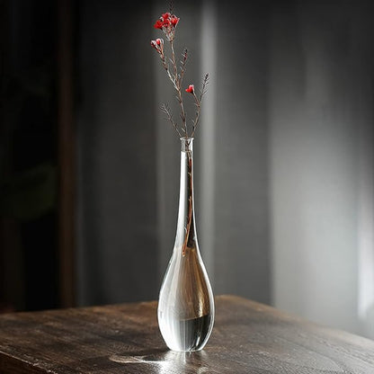 Transparent glass vase with long-stemmed roses, adding a touch of sophistication to a living room corner.