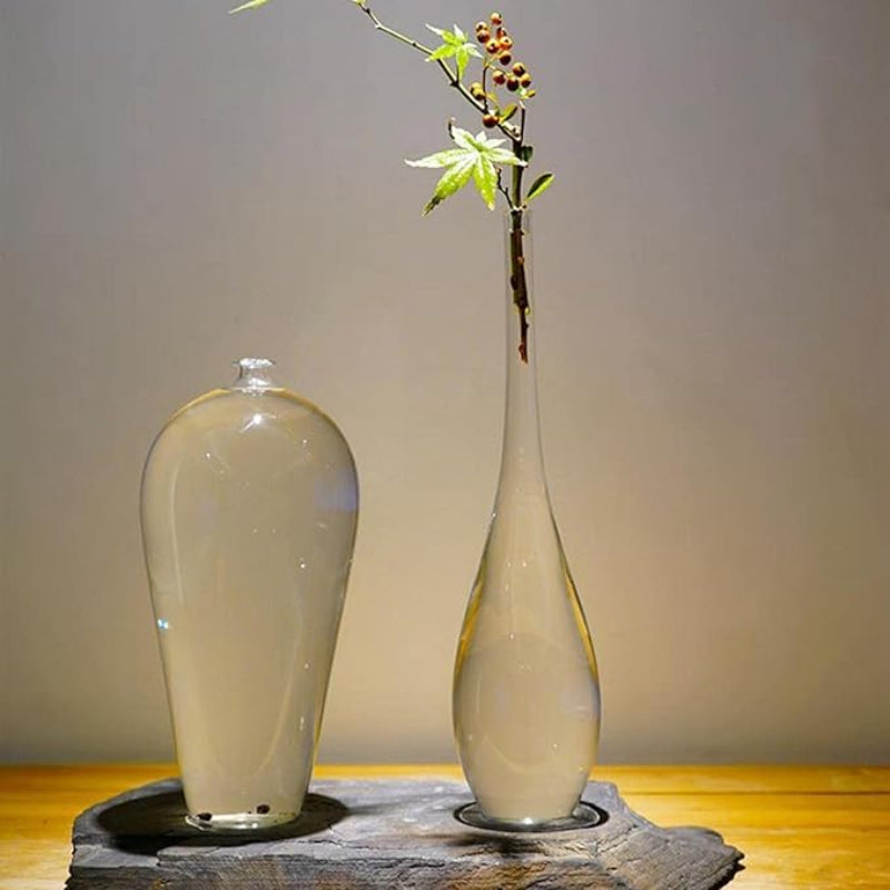 Flared glass vase with vibrant sunflowers, adding a cheerful touch to a rustic kitchen countertop.