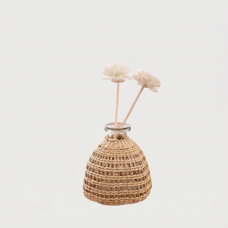 Glass vase with woven rattan on white background