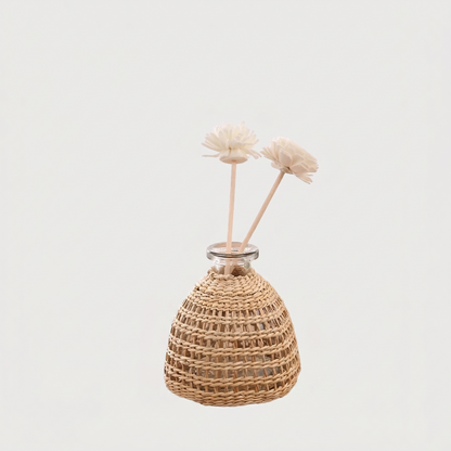 Glass vase with woven rattan on white background