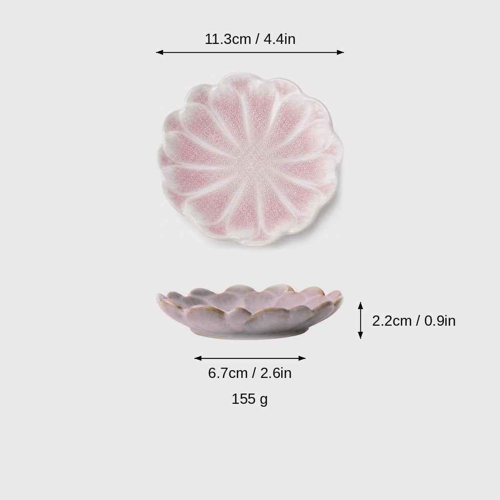 Dimensions graphic of a pink glazed scalloped ceramic dish in top and side views, labeled 11.3cm / 4.4in wide, 2.2cm / 0.9in high, 6.7cm / 2.6in base and 155 g