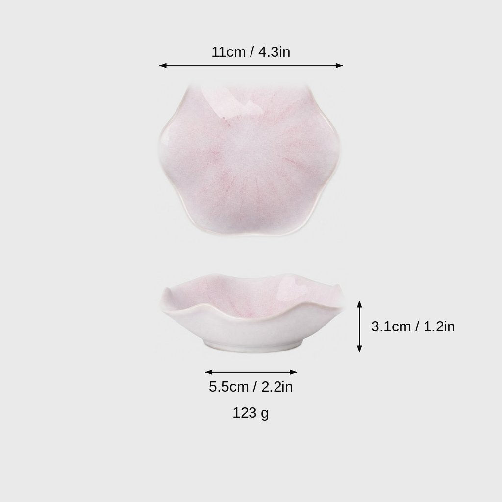 Dimensions graphic of a pale pink glazed ceramic dish with a wavy rim in top and side views, labeled 11cm / 4.3in wide, 3.1cm / 1.2in high, 5.5cm / 2.2in base and 123 g
