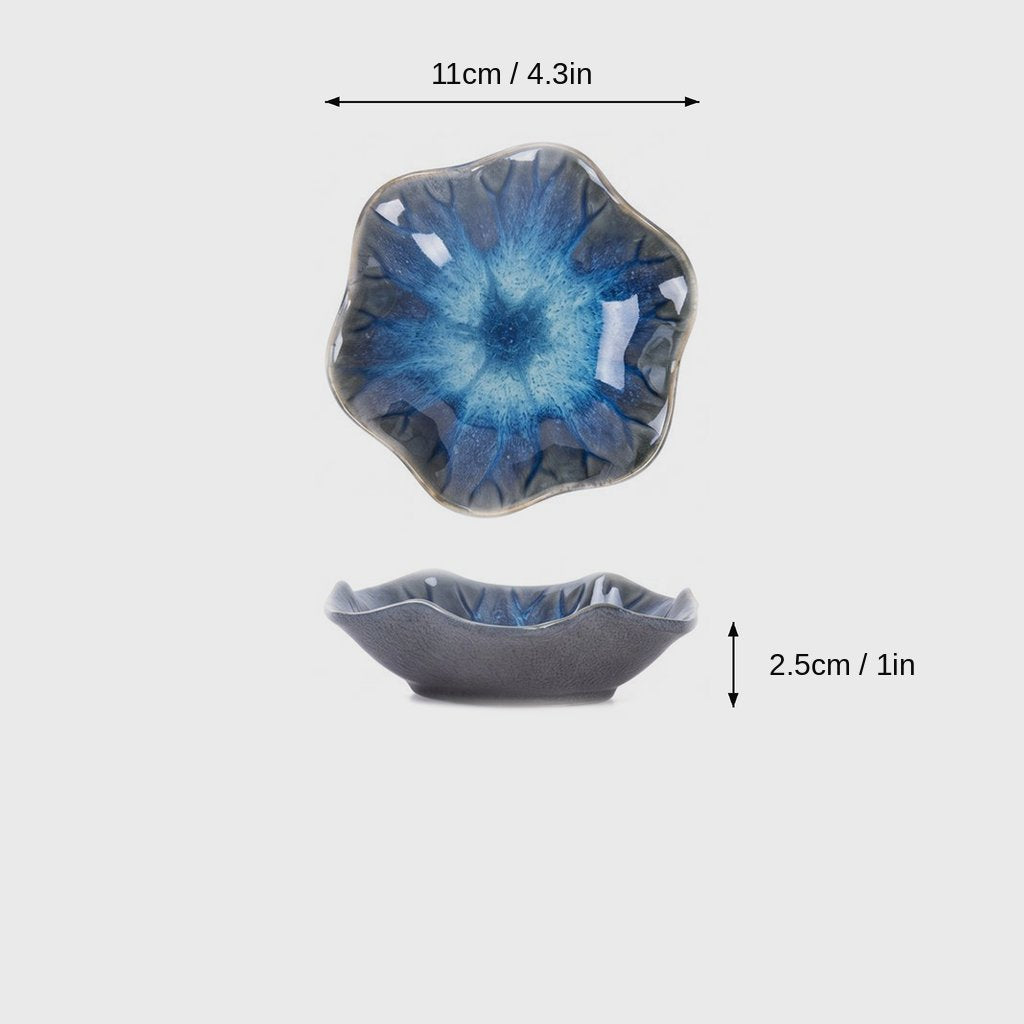 Dimensions graphic of a blue and turquoise glazed ceramic dish with a wavy rim in top and side views, labeled 11cm / 4.3in wide and 2.5cm / 1in high