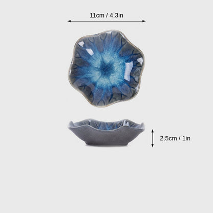 Dimensions graphic of a blue and turquoise glazed ceramic dish with a wavy rim in top and side views, labeled 11cm / 4.3in wide and 2.5cm / 1in high