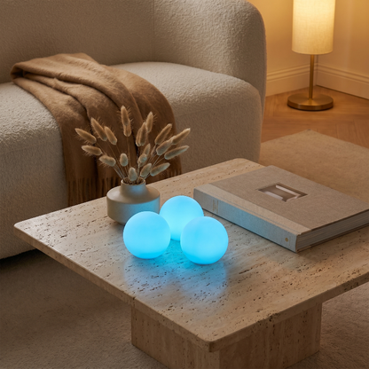 Globe accent lights glowing blue on coffee table in warm living room