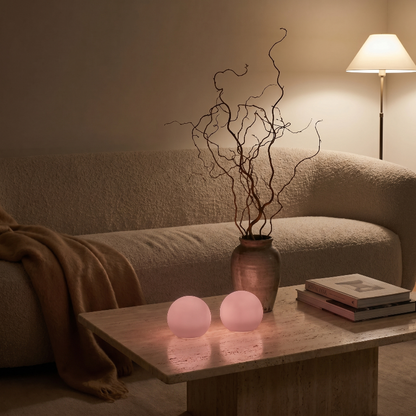 Globe accent lights in pink on side table in cozy bedroom