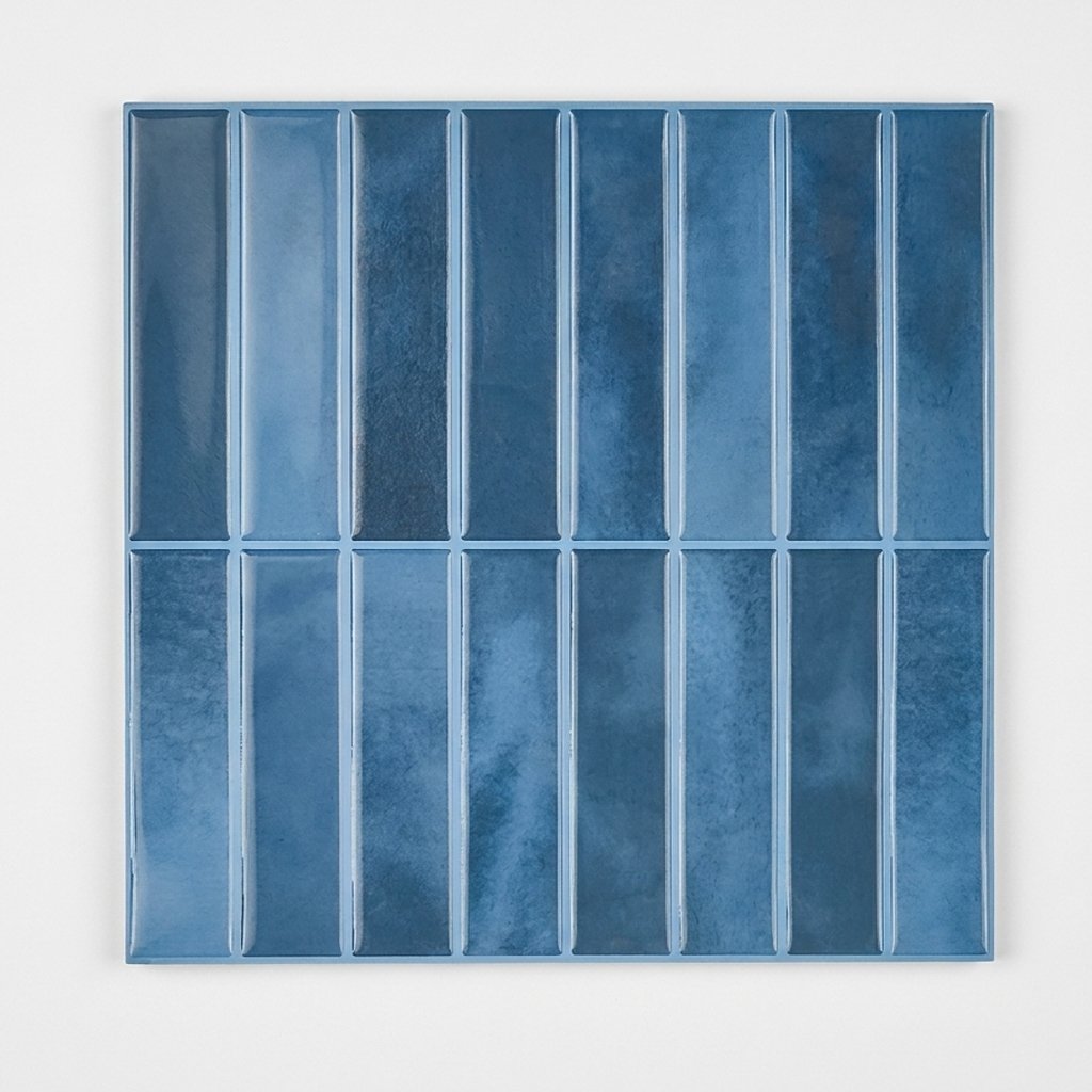 Sheet of deep blue glossy subway tile on a plain studio background