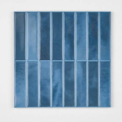 Sheet of deep blue glossy subway tile on a plain studio background