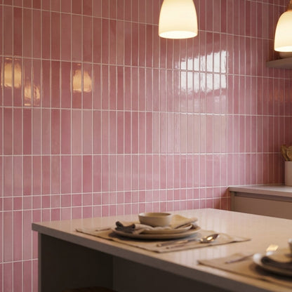 Dusty rose glossy subway tile wall in a dining room with pendant lighting and a set table