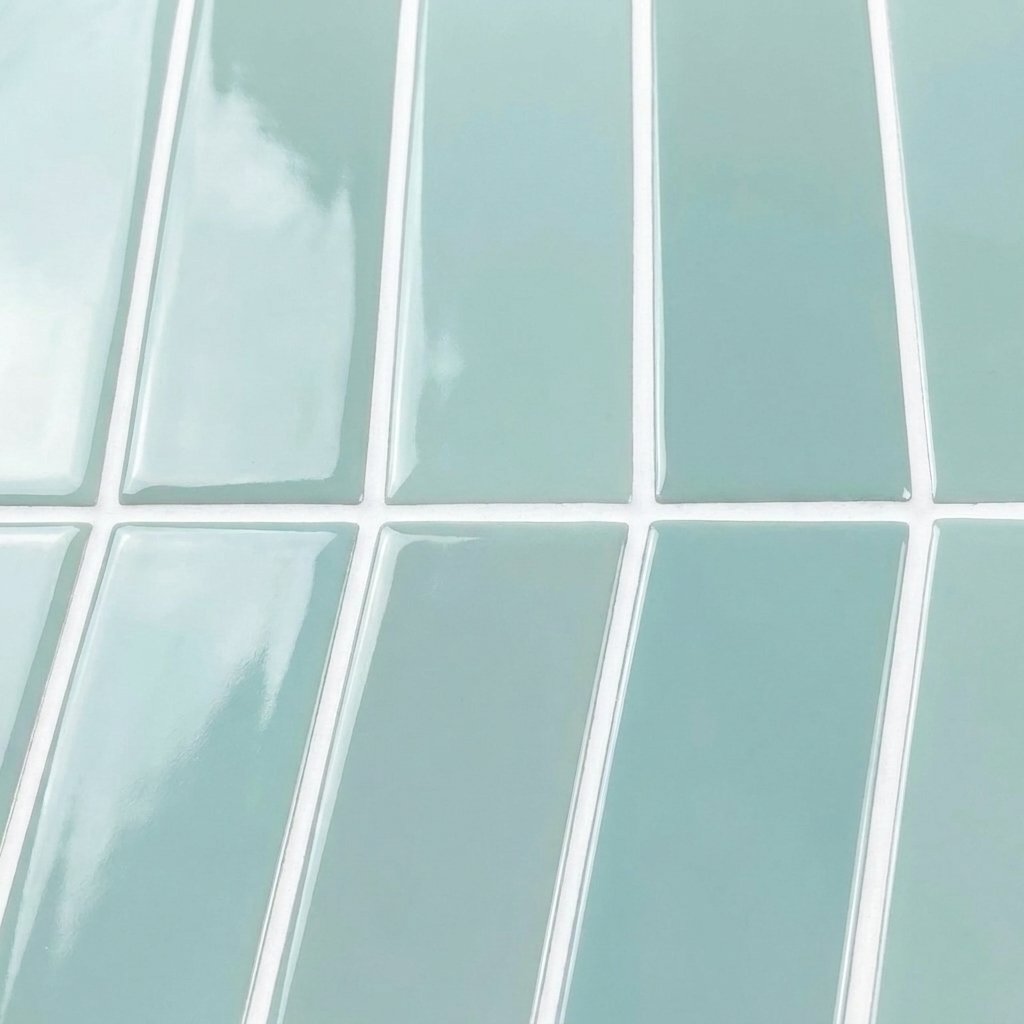 Close-up of pale sky blue glossy subway tile strips showing the glossy texture and finish