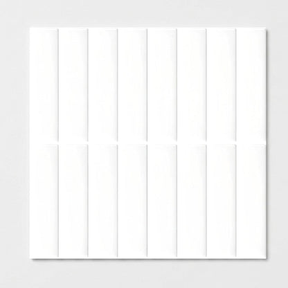 Sheet of white glossy subway tile on a plain studio background