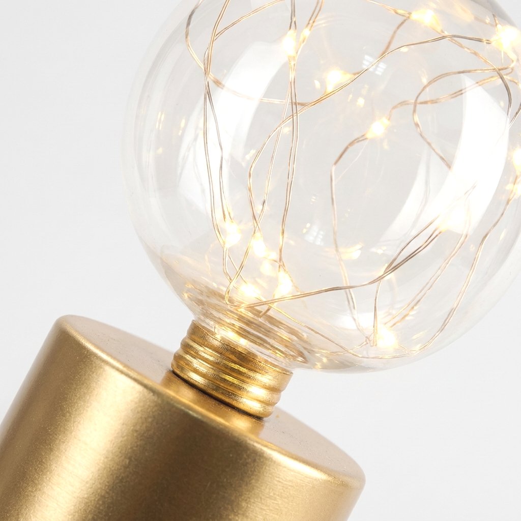 Close-up of the clear glass globe revealing the coiled gold wire LED fairy lights inside