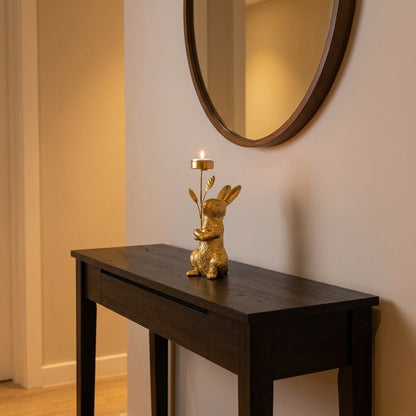 Gold standing rabbit candle holder on an entryway console table