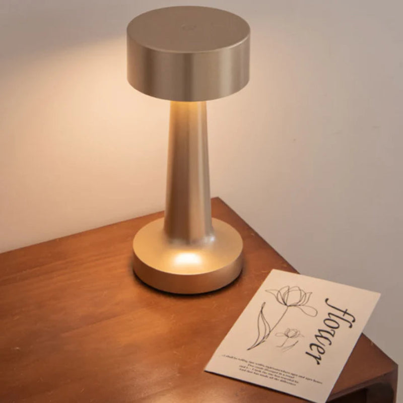 Gold table lamp styled on a bedside table.