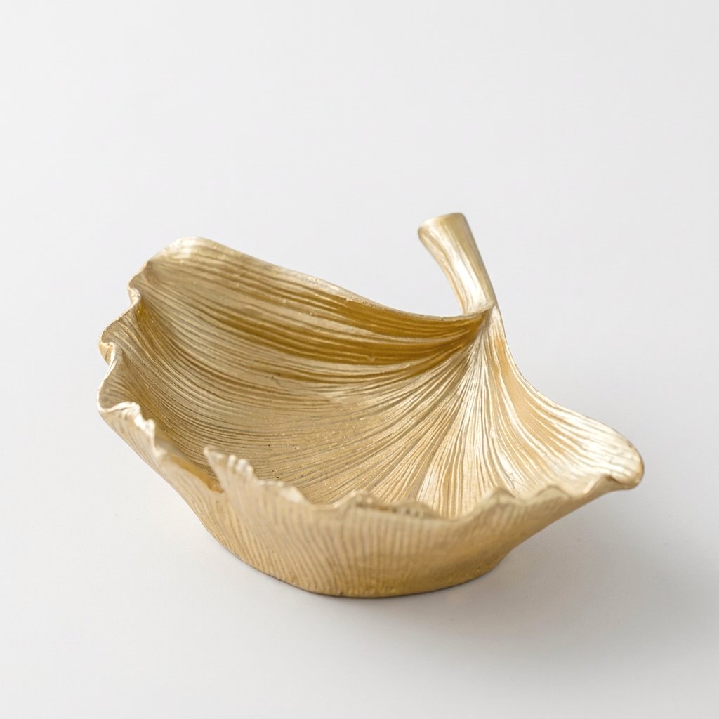 Gold ginkgo leaf tray product photo on a white background