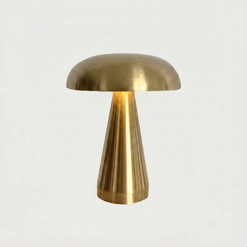 Gold metallic mushroom table lamp on white background