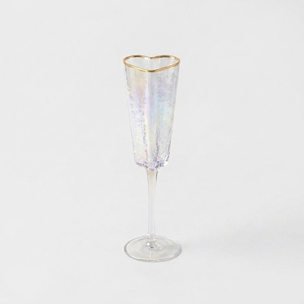 Empty gold-rim heart champagne flute product photo showing hammered glass texture