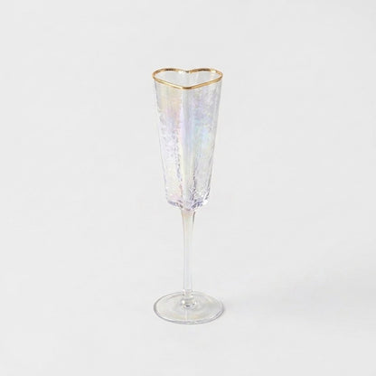 Empty gold-rim heart champagne flute product photo showing hammered glass texture