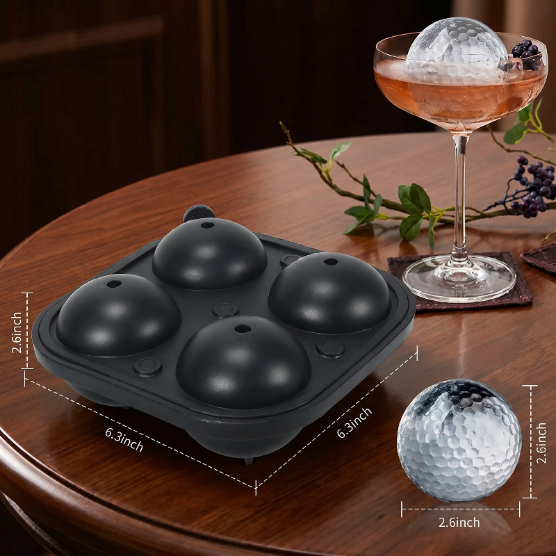 Black golf ball ice mold tray with cocktail on wooden table