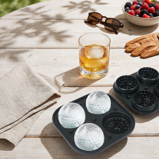 Golf ball ice mold tray with whiskey glass on outdoor table