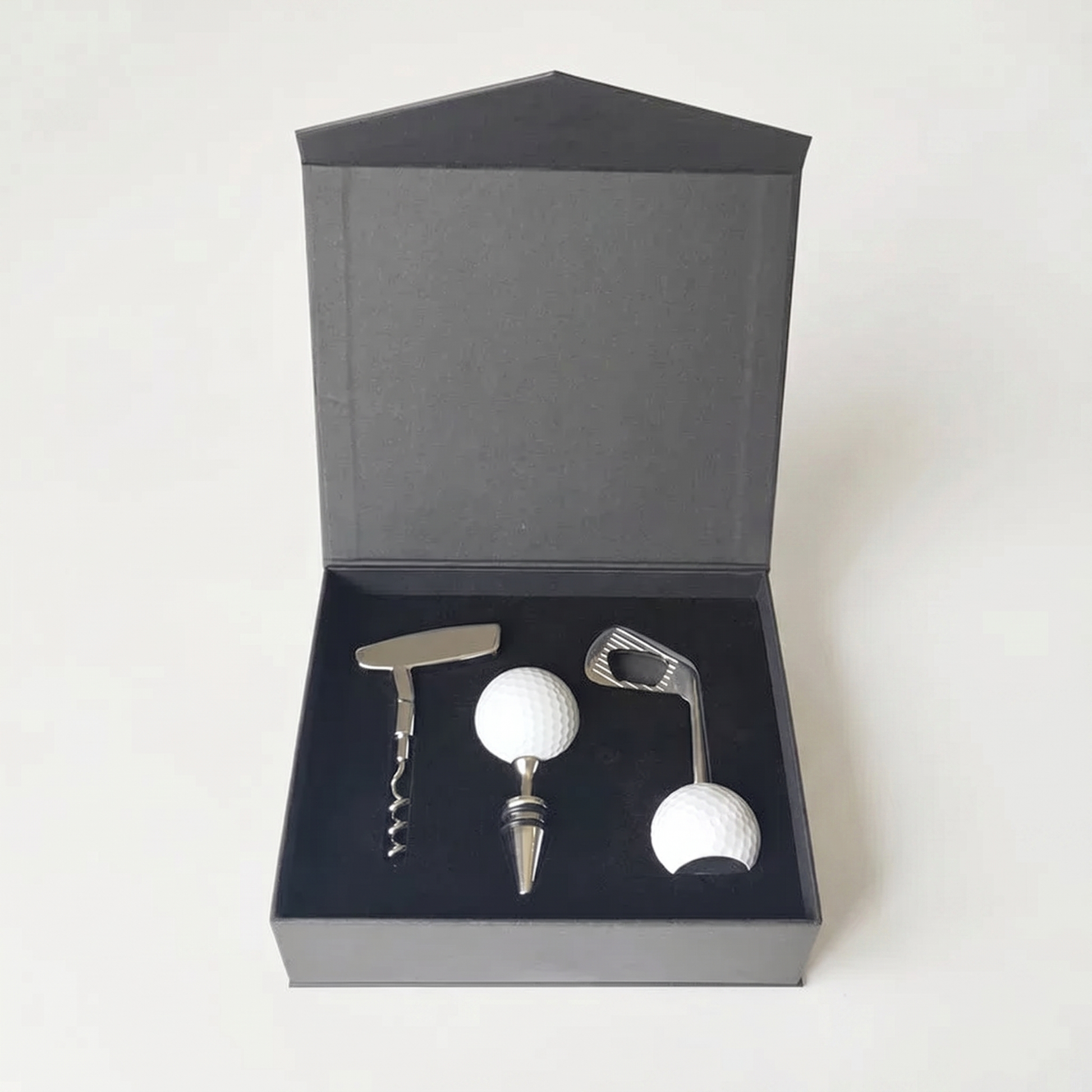 Golf-themed wine opener and bottle stopper set in a black box on a white background